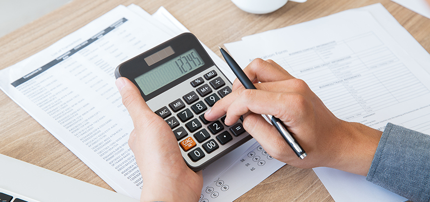 Man using calculator to count income and outcome